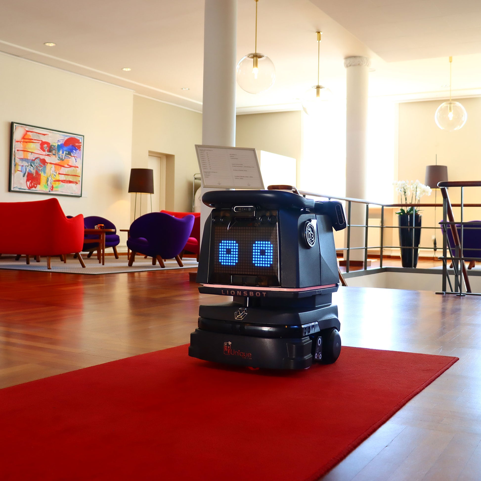 LIONSBOT R3 robotstøvsuger med ladestation, blå indikatorlys og sort krop